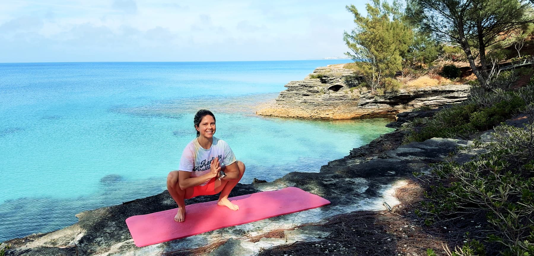 Amy - Mobility & Stretching Coach squatting with Bermuda background